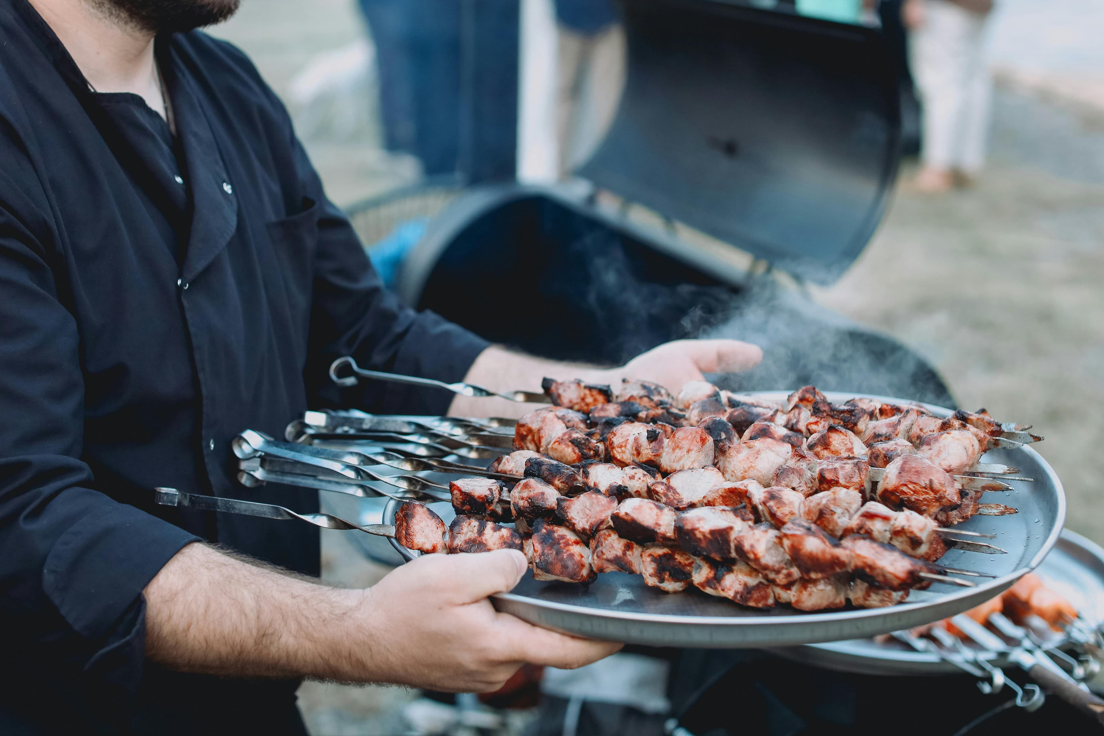 Chef preparing meat skewers